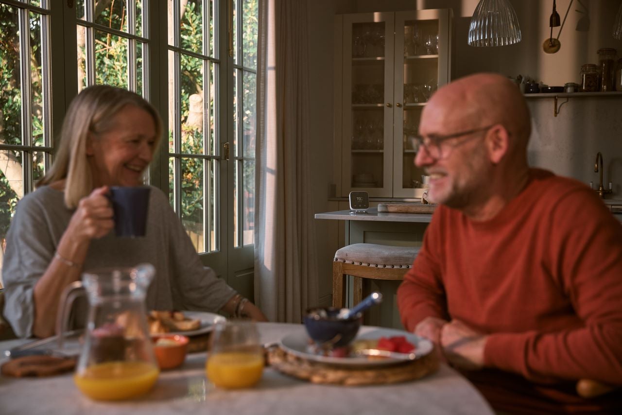 Couple enjoying breakfast at kitchen table
